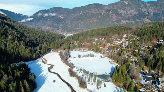 Jezero Jasna, a stunning alpine lake near Kranjska Gora, Slovenia, is a magical sight in winter when its surface freezes and the surrounding peaks are covered in snow