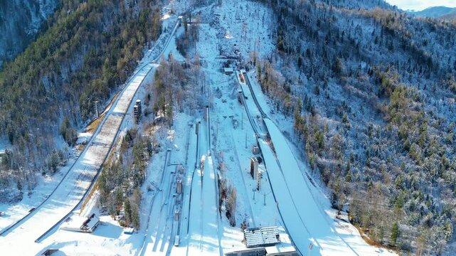 Planica Nordic Centre, nestled in the breathtaking Julian Alps of Slovenia, is a world-renowned destination for ski jumping and winter sports captured from a drone