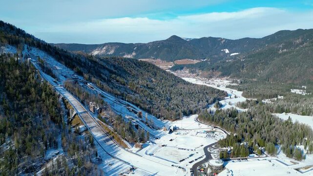Planica Nordic Centre, nestled in the breathtaking Julian Alps of Slovenia, is a world-renowned destination for ski jumping and winter sports captured from a drone