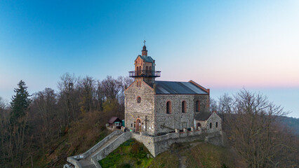 Church on Mount Ślęża at sunrise, bird's eye view, Lower Silesia, Poland.