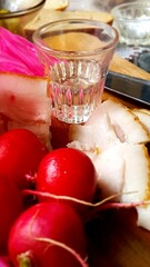 a glass of vodka and a snack