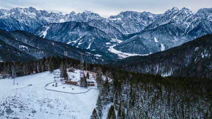 The Border Tripoint, also known as Triplice Confine, is a unique location where Austria, Italy, and Slovenia converge. Captured in the serene beauty of winter from a drone