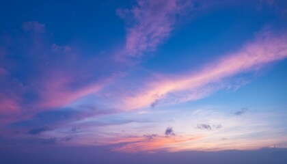 A scene of colorful clouds magically flowing over a blue sky, emitting colorful light.