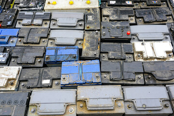 Stack of many used car batteries for recycling in a hazardous waste facility