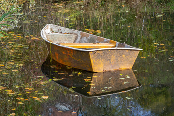 boat in a pond in an old farmers house village in South Germany