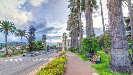 Evening view to palms on the center street of Beaulieu-sur-Mer timelapse hyperlapse.