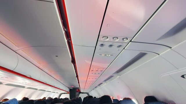 Seat belt notification light in passenger airplane cabin in turbulence flight. Flight safety regulations and procedures