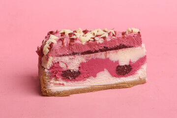 piece of raspberry cake on pink background