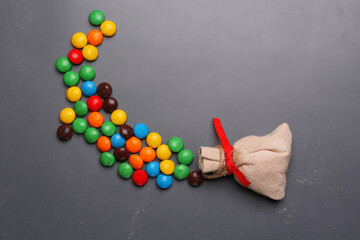 bag with scattered candies on a light background