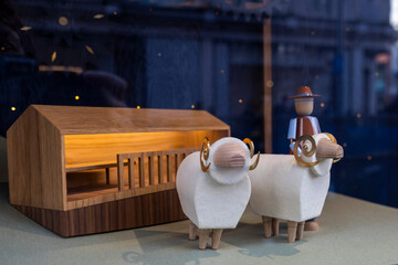.Two wooden sheep in Scandinavian style on display at a flea market.