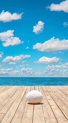 Obraz premium Serene ocean view with a wooden deck and a smooth stone in the foreground.