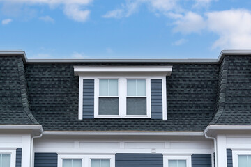 Modern mansard roof with symmetrical dormer windows in Brighton, Massachusetts, USA
