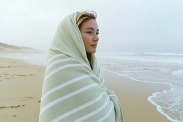 Beautiful Woman Wrapped in Striped Towel on a Beach