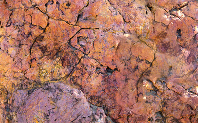 Background of natural rock that is pale pink and dark pink , purple and yellow texture