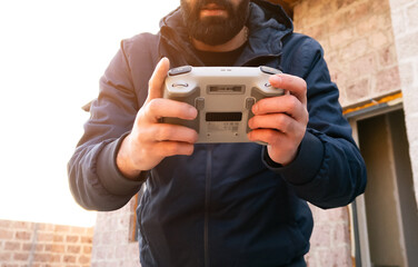 A man holds a drone control panel