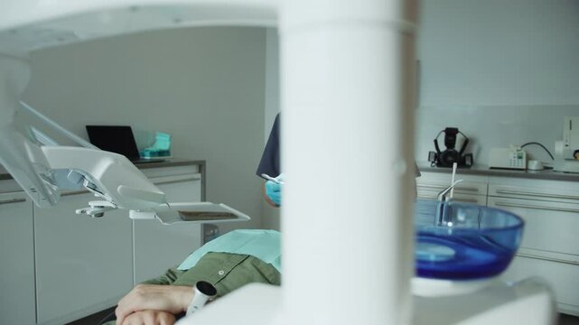 Man dentist in medical masks hold a dental instrument that treats teeth patient . Hydience and health. Modern clinic