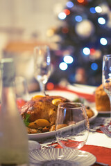 A cozy Christmas table is set with various dishes, including roasted duck and fresh salads