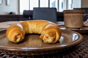 North German Hörnchen (little horn), a crescent-shaped roll, on breakfast table