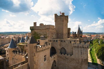 Aerial detail of the medieval towers of the tourist castle of Olite in Navarre on a sunny day with a blue sky. © Safi