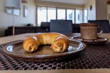 North German Hörnchen (little horn), a crescent-shaped roll, on breakfast table