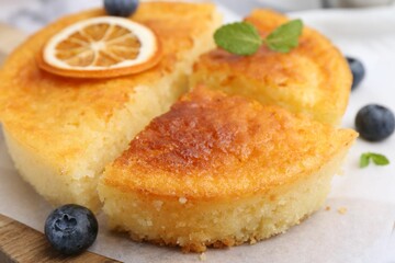 Tasty semolina cake served on white marble table, closeup