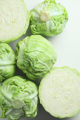Raw green cabbages on white background, flat lay