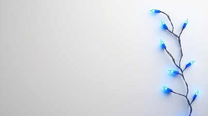 Obraz premium Single string of blue LED Christmas lights, glowing against a plain white background.