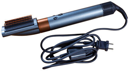 On wooden table there is branded device for creating hairstyle. Electric appliance for drying, combing and straightening hair, comb attachment. Isolated over white background