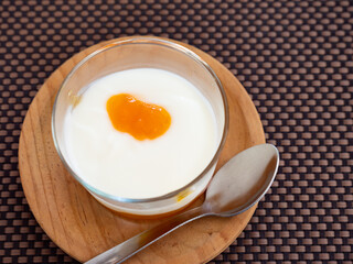 Yogurt with passion fruit marmalade served in glass for dessert
