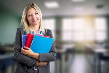 Mature female teacher posing in classroom