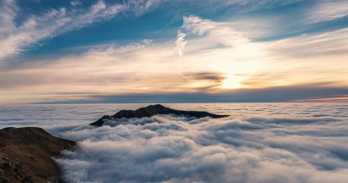 Foggy clouds flow like a ocean in evening mountains nature time lapse