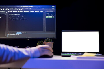 Computer scientist designing and developing software applications using isolated screen laptop. IT...