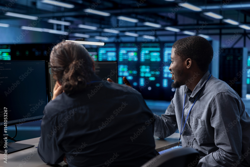 Poster teamworking colleagues reconfiguring server farm to optimize it for data processing requirements of 