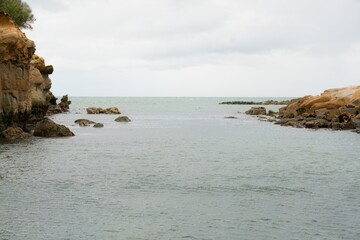 Rough Coastal Rocks at Shag Point with Calm Sea, Serene Seaside Landscape