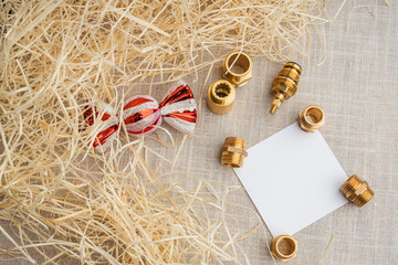 Brass hydraulic fittings and holiday decoration, an empty card with space for wishes