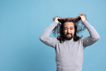 Middle eastern guy acting desperate and pulling his hair out on camera, being furious and stressed...