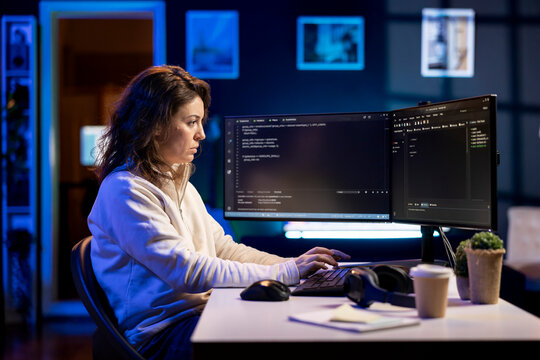 Programmer filtering malicious traffic from cybercriminals attempting to corrupt company data using computer, preventing phishing attacks. Woman typing on keyboard, designing software programs