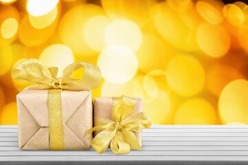 Set of colored gift boxes with bows at bokeh background
