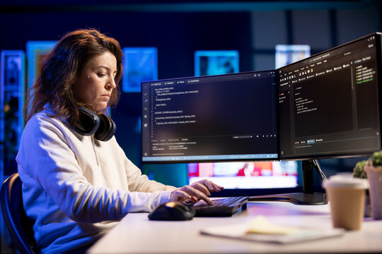 Freelancing professional working from home developing software in Java programming language using PC. Software technician in apartment writing lines of code on computer using keyboard