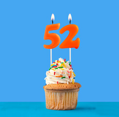 Orange birthday candle and cupcake - Number 52