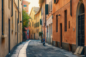 Fototapeta premium Medieval narrow street with nobody in Bologna old town, Emilia Romagna, Italy at sunrise. Italian street with colorful building facades. Travel destination in Europe