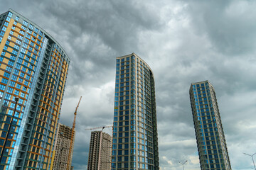 Fototapeta premium Modern skyscrapers in the new area. Tall buildings made of glass against the sky. Buying or renting luxury real estate. Moscow City