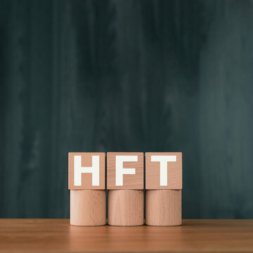 There is wood cube with the word HFT. It is an abbreviation for High Frequency Trade as eye-catching image.