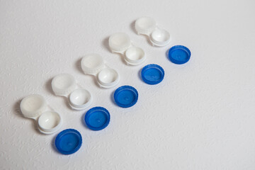 Contact lenses on white background, top view