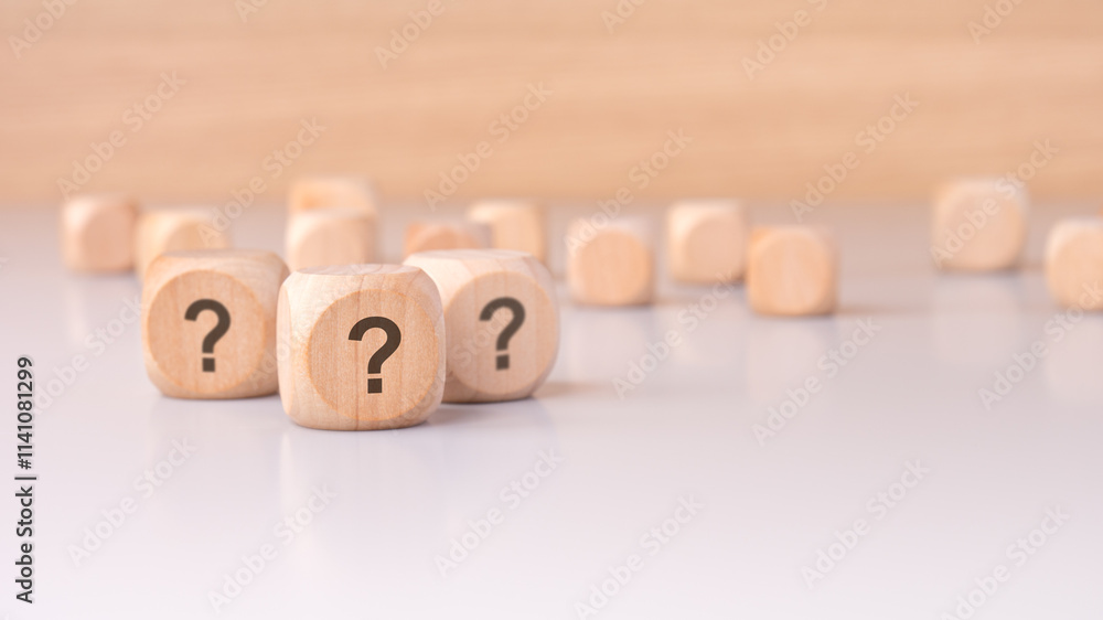 Poster on the table sits a collection of mysterious wooden blocks adorned with question marks