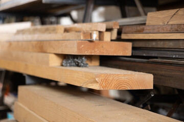 Stacks of wood planks in a lumberyard. Timber planks stacked to season