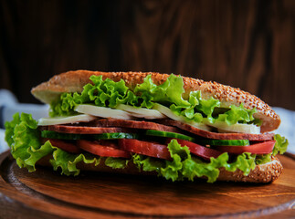 A fresh, vibrant sandwich bursting with crisp vegetables, savory meat, and cheese, served on a sesame roll — the essence of wholesome comfort food.