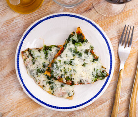 Appetizing pizza with tender greens of spinach and cheese
