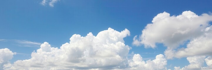 white fluffy clouds floating in a clear blue summer sky, atmosphere, scenic