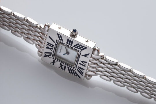 Side view of Cartier watch, Obus model. Quartz watch in white gold with mother of pearl dial. Milan, Italy August 22, 2024